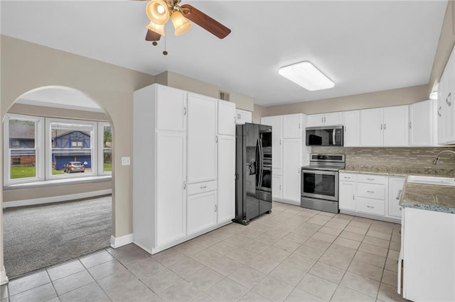838 E 125th Ter, Olathe, KS 66061 - kitchen with stainless steel appliances, a sink, light tile patterned flooring, and white cabinetry