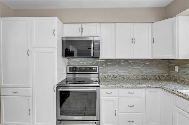 838 E 125th Ter, Olathe, KS 66061 - kitchen with stainless steel appliances, white cabinetry, backsplash, and light stone counters