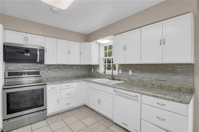 838 E 125th Ter, Olathe, KS 66061 - kitchen with stainless steel appliances, a sink, decorative backsplash, and white cabinets