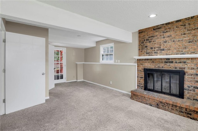 838 E 125th Ter, Olathe, KS 66061 - unfurnished living room with carpet flooring, a textured ceiling, a brick fireplace, and baseboards