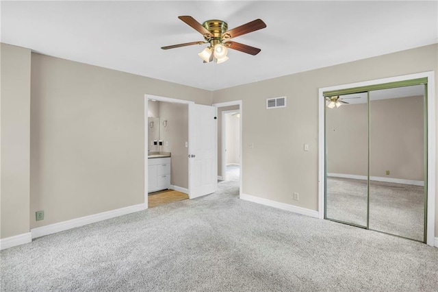 838 E 125th Ter, Olathe, KS 66061 - unfurnished bedroom featuring light carpet, baseboards, a closet, a ceiling fan, and ensuite bathroom