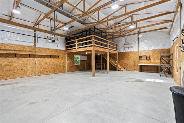 17105 Bo Cir, Tonganoxie, KS 66086 - misc room with a garage, concrete flooring, and a towering ceiling