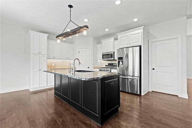 17105 Bo Cir, Tonganoxie, KS 66086 - kitchen featuring appliances with stainless steel finishes, dark wood-style flooring, a sink, white cabinets, and recessed lighting