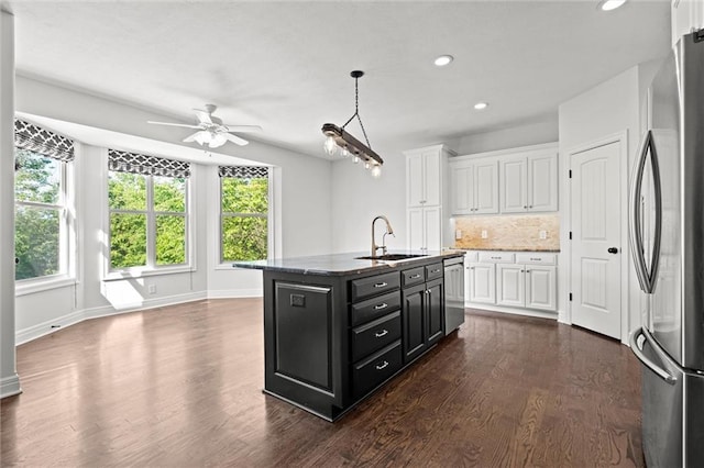 17105 Bo Cir, Tonganoxie, KS 66086 - kitchen with appliances with stainless steel finishes, a sink, dark cabinets, a ceiling fan, and white cabinets