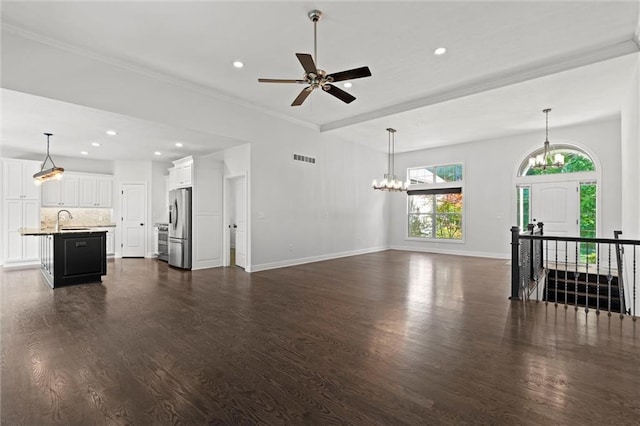 17105 Bo Cir, Tonganoxie, KS 66086 - unfurnished living room with dark wood finished floors, a chandelier, baseboards, a sink, and recessed lighting