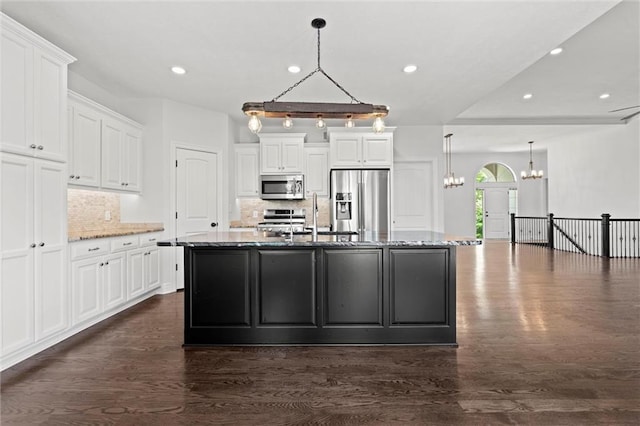 17105 Bo Cir, Tonganoxie, KS 66086 - kitchen with appliances with stainless steel finishes, a chandelier, a sink, dark wood-style flooring, and recessed lighting