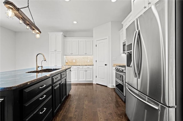 17105 Bo Cir, Tonganoxie, KS 66086 - kitchen with stainless steel appliances, a sink, white cabinetry, dark wood finished floors, and dark cabinets