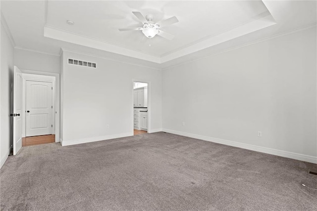 17105 Bo Cir, Tonganoxie, KS 66086 - empty room featuring a tray ceiling, carpet floors, ornamental molding, and ceiling fan