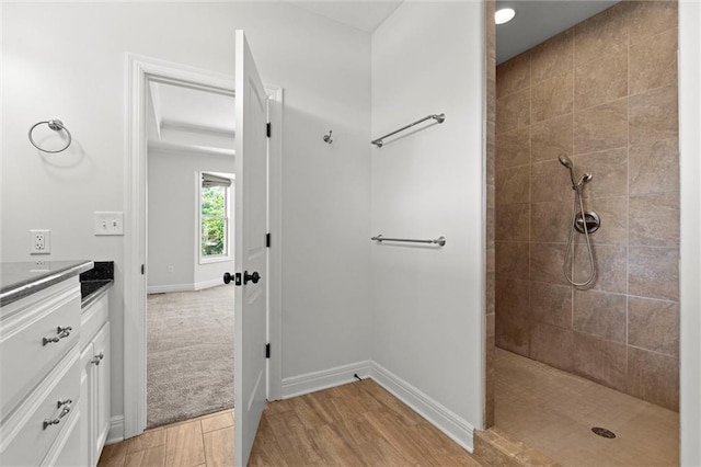 17105 Bo Cir, Tonganoxie, KS 66086 - full bathroom with a walk in shower, vanity, wood finished floors, and baseboards