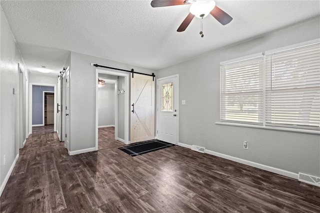 16807 E 3rd Ter N, Independence, MO 64056 - entrance foyer featuring a barn door, wood finished floors, a textured ceiling, and ceiling fan