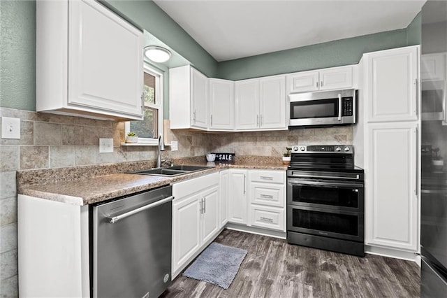 16807 E 3rd Ter N, Independence, MO 64056 - kitchen featuring appliances with stainless steel finishes, white cabinetry, and dark wood-type flooring