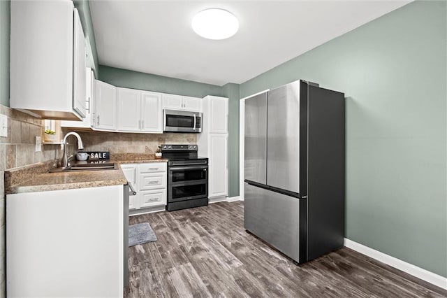 16807 E 3rd Ter N, Independence, MO 64056 - kitchen featuring stainless steel appliances, white cabinetry, tasteful backsplash, dark wood-style floors, and light countertops