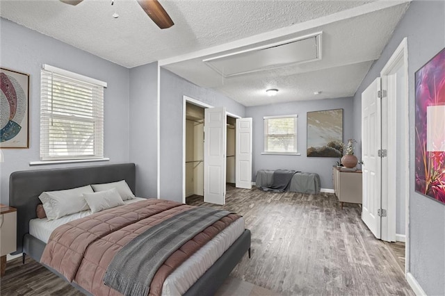 16807 E 3rd Ter N, Independence, MO 64056 - bedroom with attic access, wood finished floors, a textured ceiling, and a ceiling fan