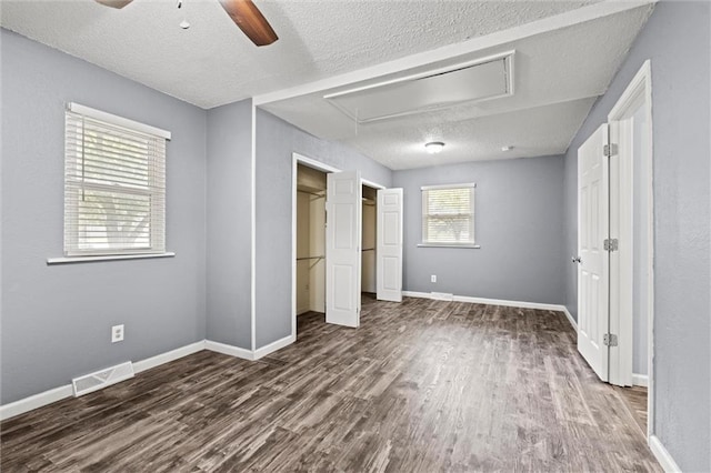 16807 E 3rd Ter N, Independence, MO 64056 - unfurnished bedroom with attic access, wood finished floors, a textured ceiling, ceiling fan, and a closet