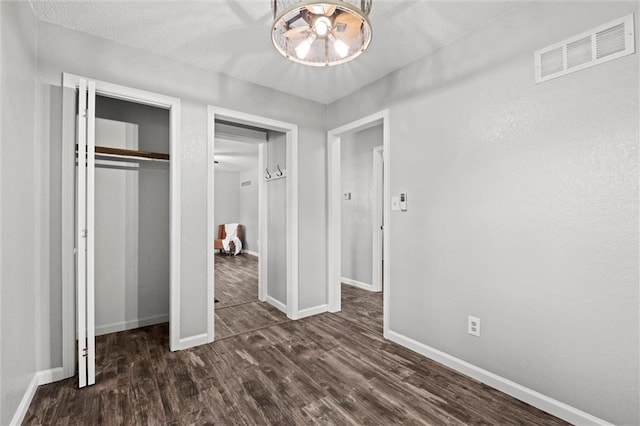 16807 E 3rd Ter N, Independence, MO 64056 - unfurnished bedroom with dark wood finished floors, a chandelier, and a closet