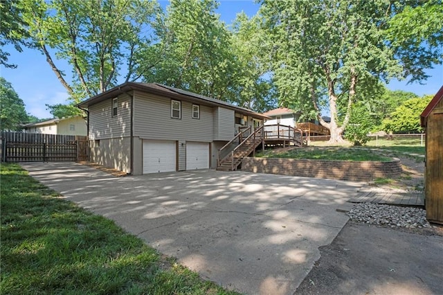 16807 E 3rd Ter N, Independence, MO 64056 - view of front of home with a wooden deck, a garage, stairs, and concrete driveway