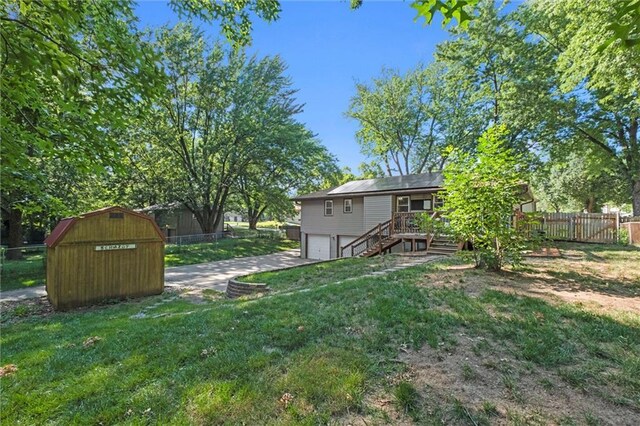 16807 E 3rd Ter N, Independence, MO 64056 - view of yard featuring a garage, stairway, driveway, and a wooden deck