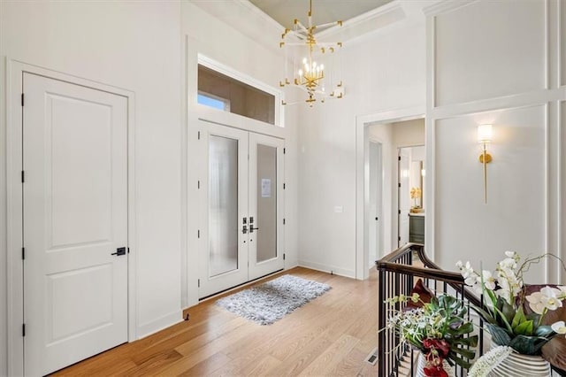 8013 Payne St, Shawnee, KS 66220 - entrance foyer featuring a chandelier, light wood finished floors, french doors, baseboards, and a high ceiling