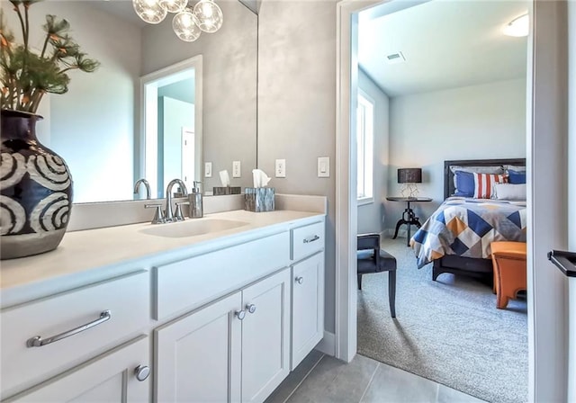 8013 Payne St, Shawnee, KS 66220 - ensuite bathroom featuring vanity, tile patterned flooring, and a chandelier