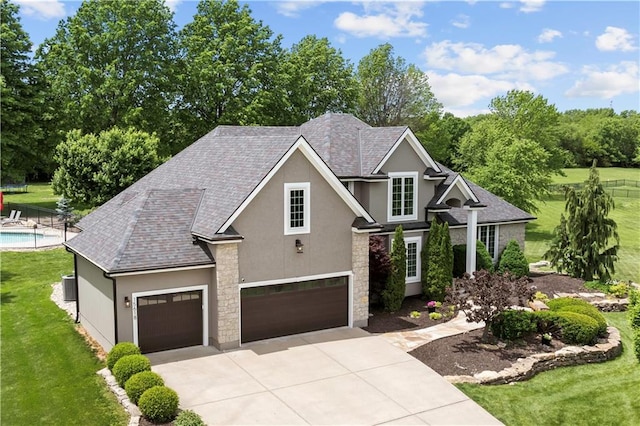 15618 Meadowbrook Ct, Raymore, MO 64083 - traditional home with stucco siding, stone siding, concrete driveway, and a shingled roof