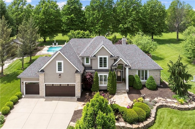 15618 Meadowbrook Ct, Raymore, MO 64083 - traditional home with stucco siding, driveway, a front yard, and stone siding