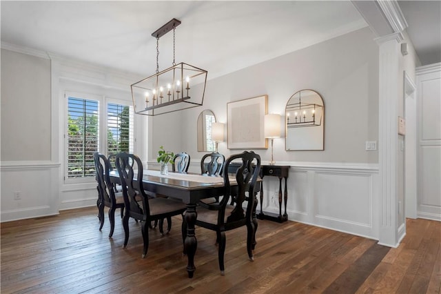 15618 Meadowbrook Ct, Raymore, MO 64083 - dining room featuring a chandelier, crown molding, dark wood-style flooring, wainscoting, and a decorative wall