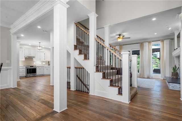 15618 Meadowbrook Ct, Raymore, MO 64083 - staircase featuring ornate columns, ornamental molding, wood-type flooring, ceiling fan, and recessed lighting