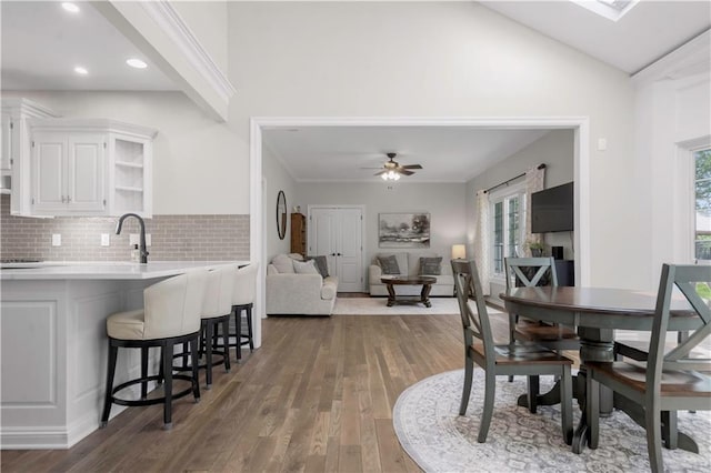 15618 Meadowbrook Ct, Raymore, MO 64083 - dining room featuring wood finished floors, ceiling fan, vaulted ceiling, and recessed lighting