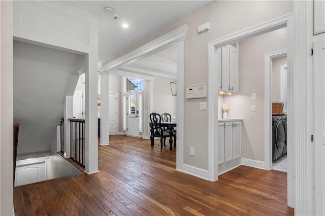 15618 Meadowbrook Ct, Raymore, MO 64083 - hall with hardwood / wood-style floors, washing machine and dryer, baseboards, an upstairs landing, and lofted ceiling