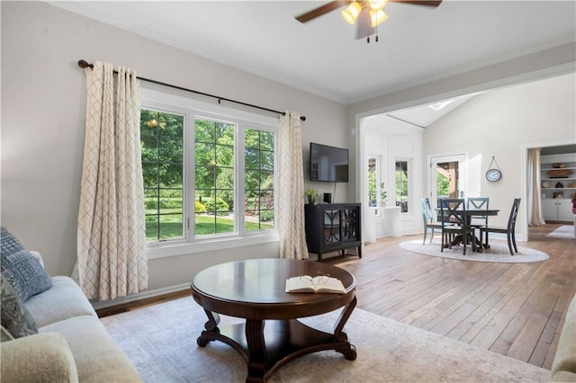 15618 Meadowbrook Ct, Raymore, MO 64083 - living area featuring hardwood / wood-style flooring, a ceiling fan, lofted ceiling, baseboards, and crown molding