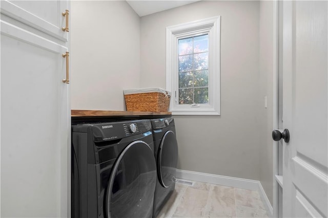 15618 Meadowbrook Ct, Raymore, MO 64083 - laundry room with washing machine and clothes dryer, cabinet space, and baseboards