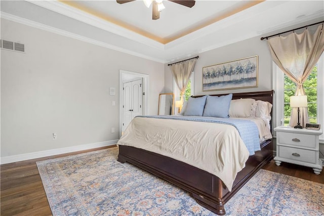 15618 Meadowbrook Ct, Raymore, MO 64083 - bedroom with dark wood-style flooring, a raised ceiling, baseboards, ornamental molding, and a ceiling fan