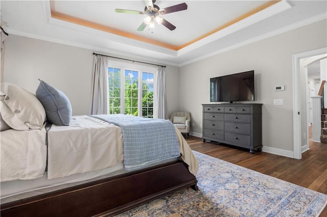 15618 Meadowbrook Ct, Raymore, MO 64083 - bedroom featuring a tray ceiling, wood finished floors, baseboards, crown molding, and a ceiling fan