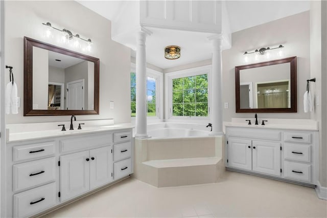 15618 Meadowbrook Ct, Raymore, MO 64083 - full bath with two vanities, a garden tub, decorative columns, and tile patterned flooring