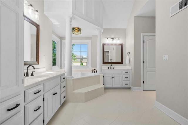 15618 Meadowbrook Ct, Raymore, MO 64083 - full bath featuring two vanities, a bath, decorative columns, tile patterned flooring, and baseboards
