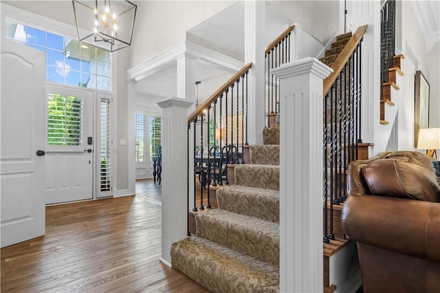 15618 Meadowbrook Ct, Raymore, MO 64083 - entrance foyer featuring stairway, a high ceiling, hardwood / wood-style flooring, a chandelier, and ornate columns