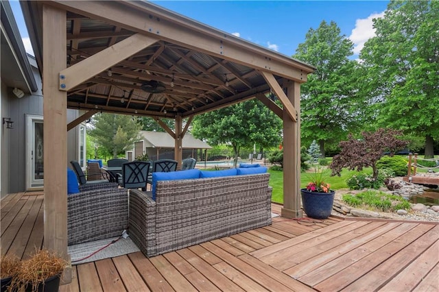 15618 Meadowbrook Ct, Raymore, MO 64083 - wooden terrace featuring a ceiling fan, an outdoor hangout area, a gazebo, and outdoor dining space