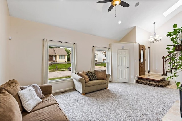 14401 Craig Ave, Grandview, MO 64030 - living area with a chandelier, a skylight, vaulted ceiling, ceiling fan, and carpet flooring