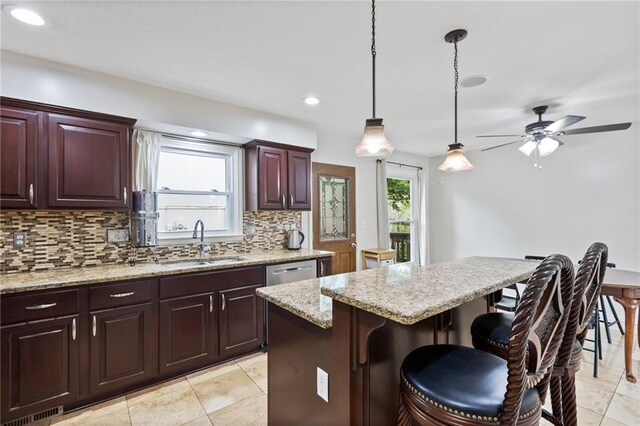 14401 Craig Ave, Grandview, MO 64030 - kitchen with tasteful backsplash, a sink, a breakfast bar area, dishwasher, and ceiling fan