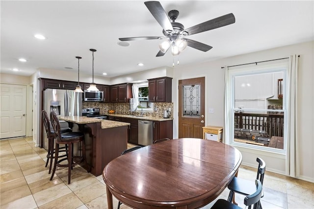 14401 Craig Ave, Grandview, MO 64030 - dining room featuring a ceiling fan, baseboards, recessed lighting, and light tile patterned floors