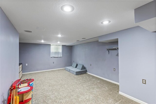 14401 Craig Ave, Grandview, MO 64030 - below grade area featuring carpet flooring, recessed lighting, baseboards, and a textured ceiling