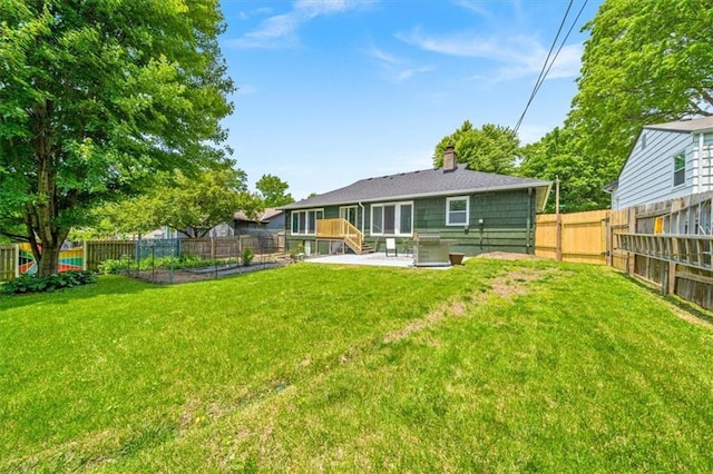 811 W 86th Ter, Kansas City, MO 64114 - back of house with a fenced backyard, a chimney, and a patio area