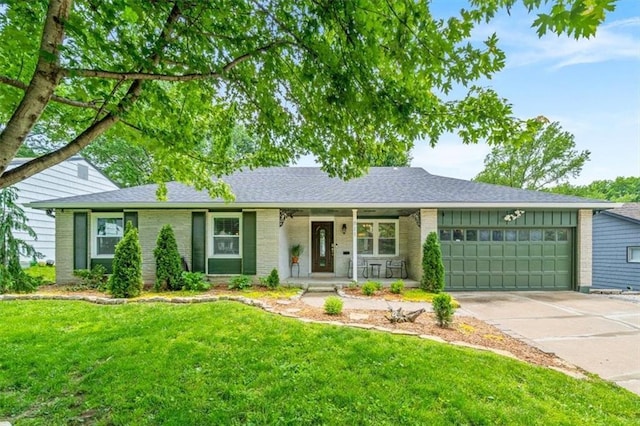 811 W 86th Ter, Kansas City, MO 64114 - single story home with brick siding, a garage, driveway, a front yard, and covered porch