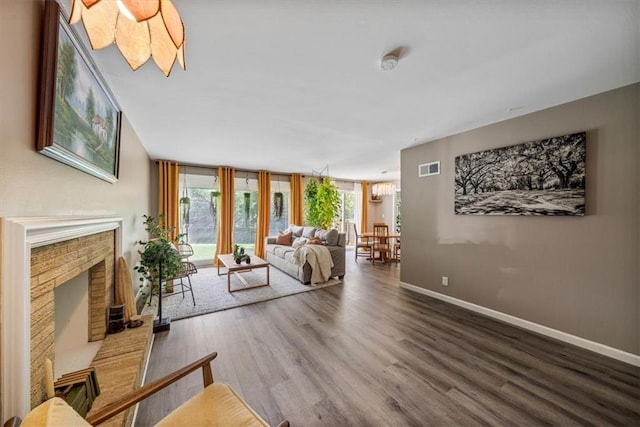 811 W 86th Ter, Kansas City, MO 64114 - living room with wood finished floors and a fireplace