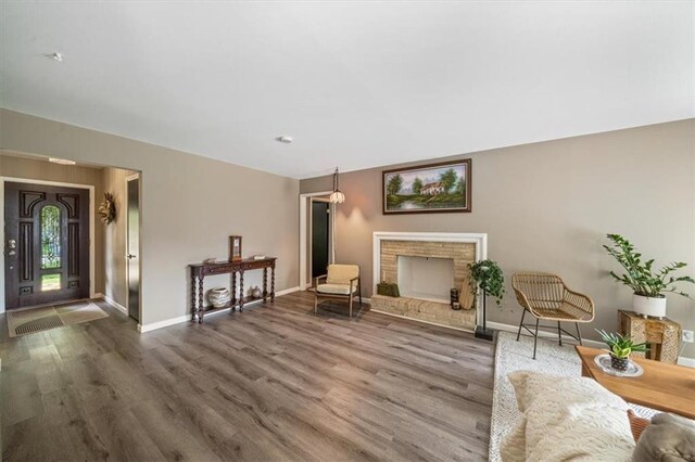 811 W 86th Ter, Kansas City, MO 64114 - living area featuring wood finished floors and a brick fireplace