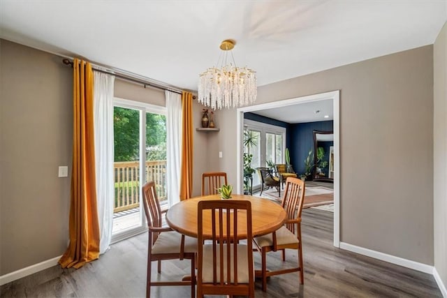 811 W 86th Ter, Kansas City, MO 64114 - dining space featuring plenty of natural light, a chandelier, and wood finished floors