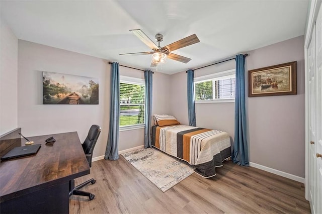 811 W 86th Ter, Kansas City, MO 64114 - bedroom with wood finished floors, an office area, and a ceiling fan