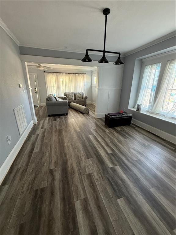 418 N 8th St, Independence, KS 67301 - living room with ornamental molding, baseboards, and dark wood finished floors
