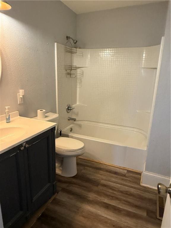 418 N 8th St, Independence, KS 67301 - bathroom with wood finished floors, vanity, toilet, and shower / tub combination
