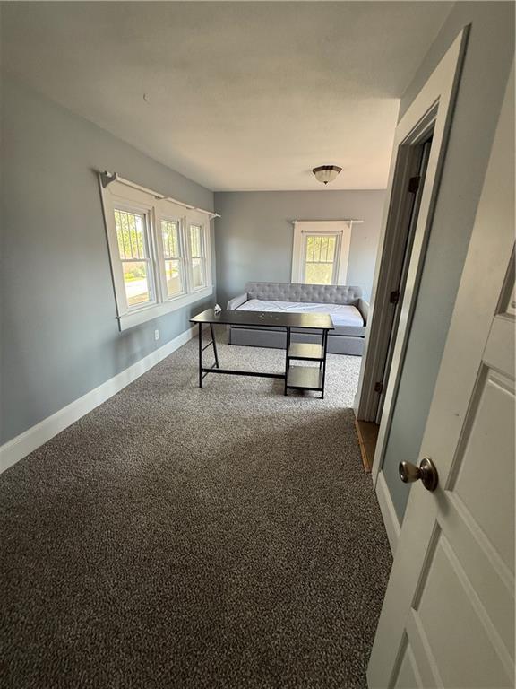 418 N 8th St, Independence, KS 67301 - carpeted bedroom featuring baseboards